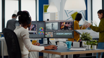 Editors color-grading photo and video work at studio monitors